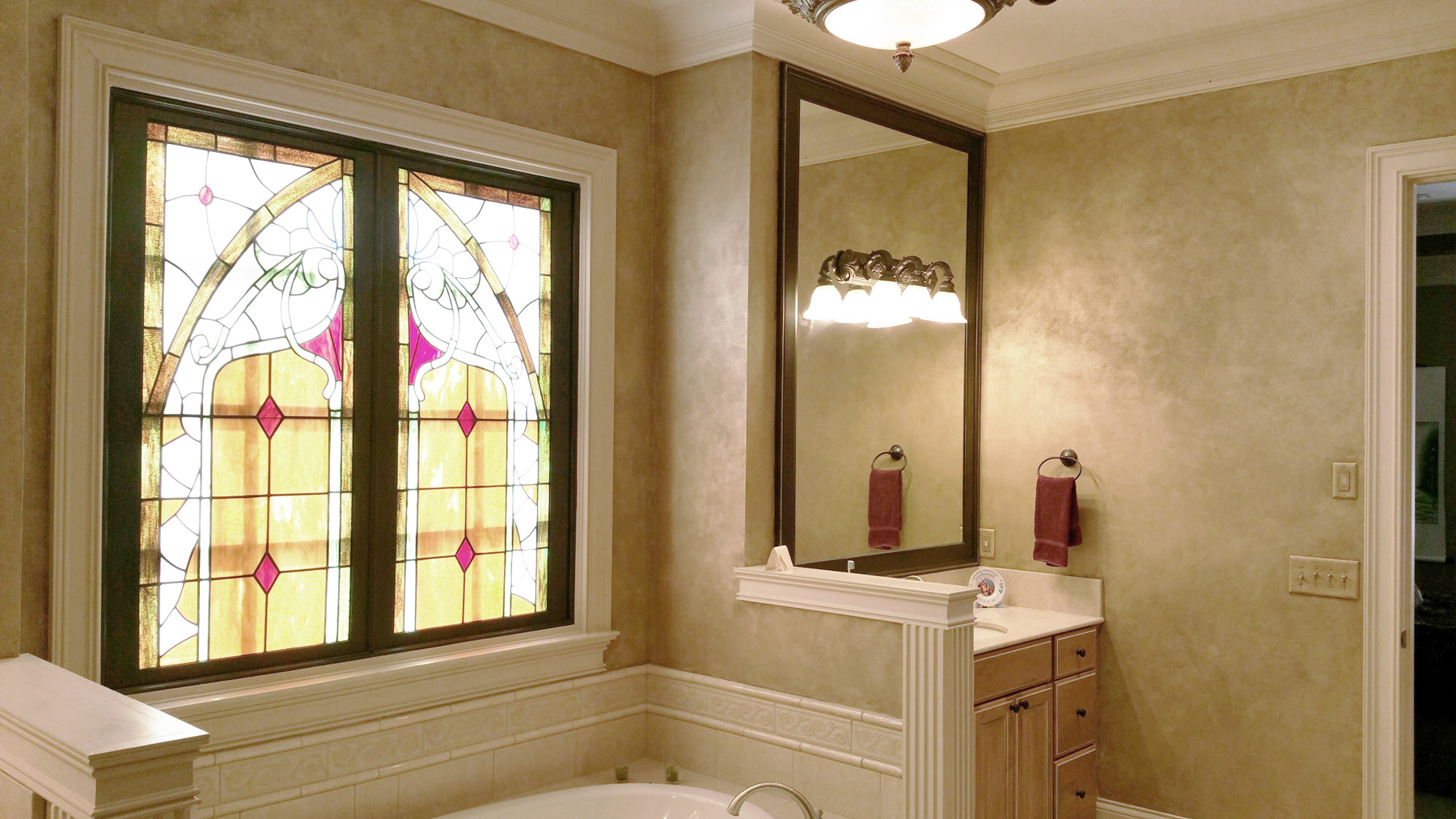 Master Bath Shimmering Lusterstone walls with custom faux designed mirror frames.