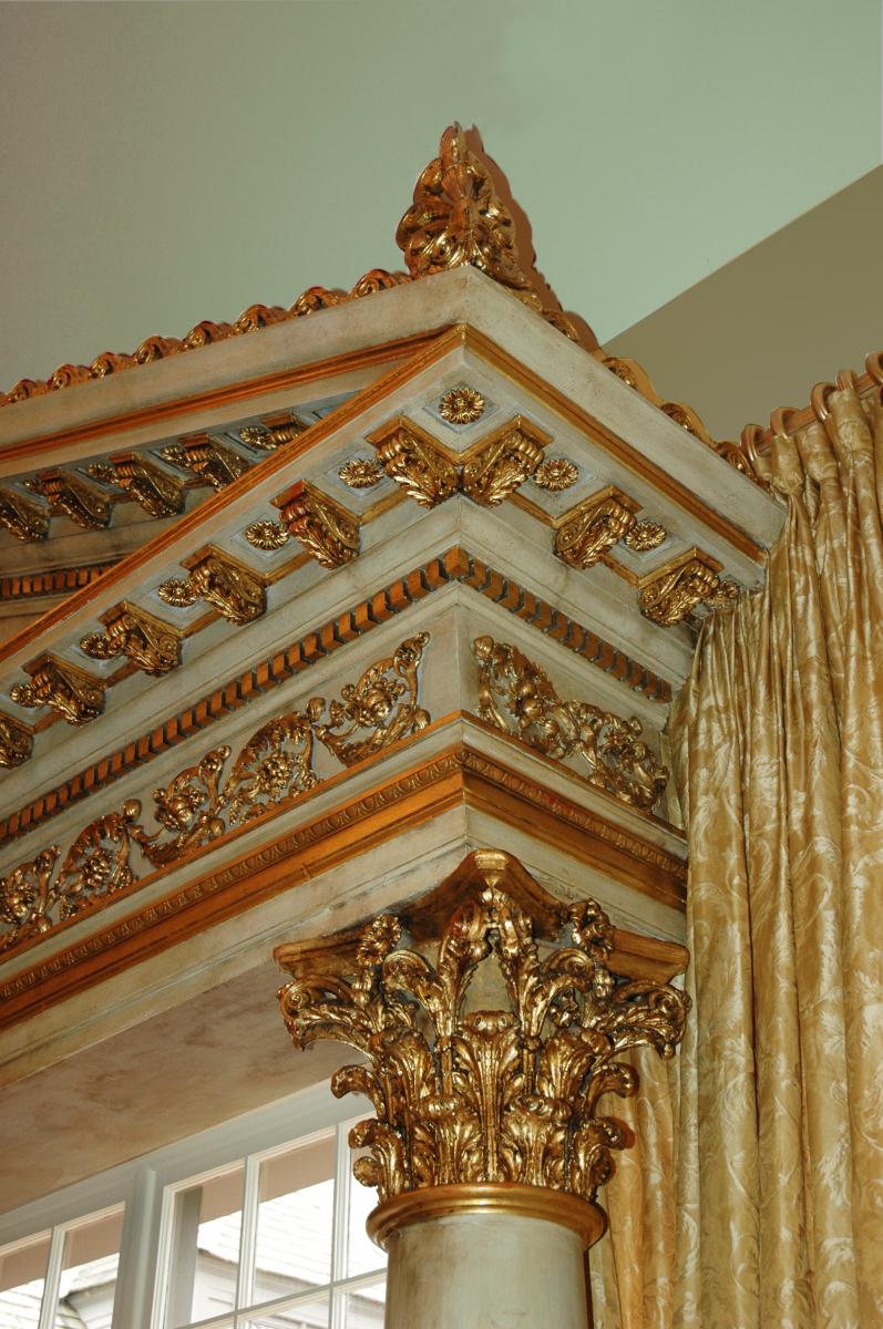 Entryway pediment adorned in 23.75 karat gold leafing and hand painted white sepia marble.