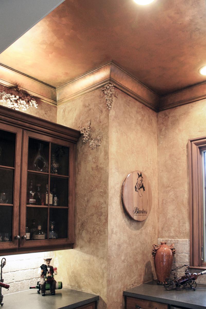 Faux grapes over sculpted over bourbon and wine cabinet.