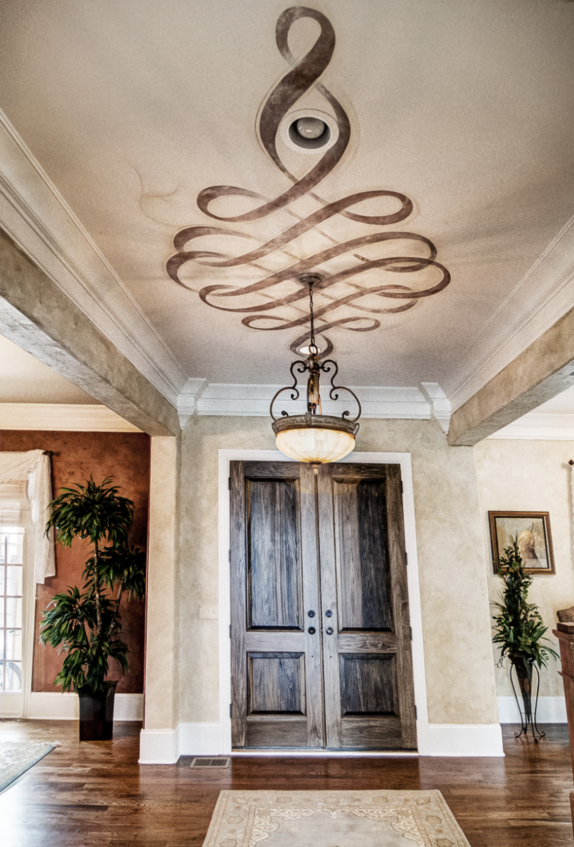 European plaster walls with a hand painted metallic Modello ceiling scroll fresco.