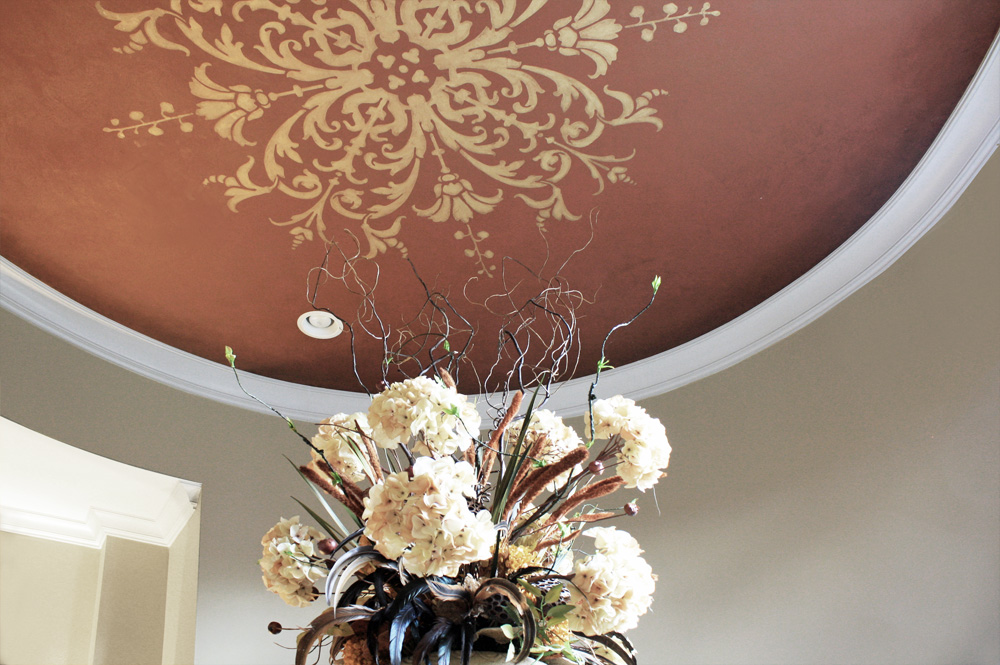 Custom hand painted ceiling stencil with warm toning over glaze close up.