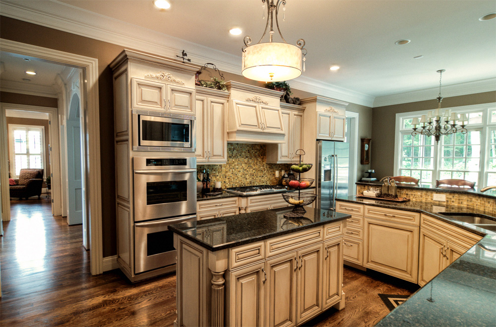 Before and After – These kitchen cabinets and breakfast bar were given a new life with modern color mixture and furniture glazing technique in Franklin, TN.