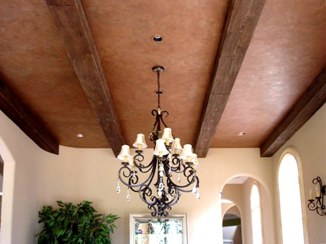 Clay colored plaster and wood grained beams.